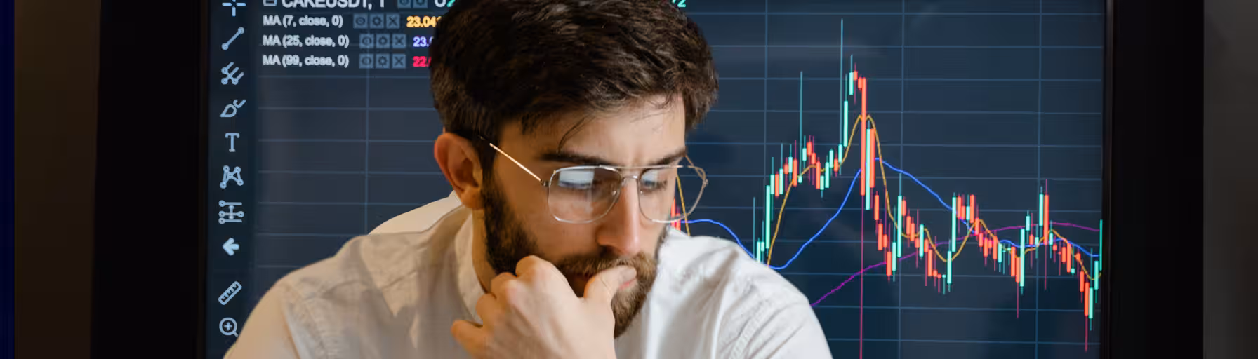 Man looking concerned with options trading graph behind him